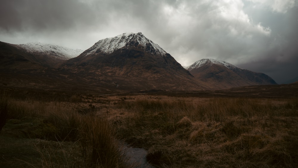 a mountain range with a stream running through it