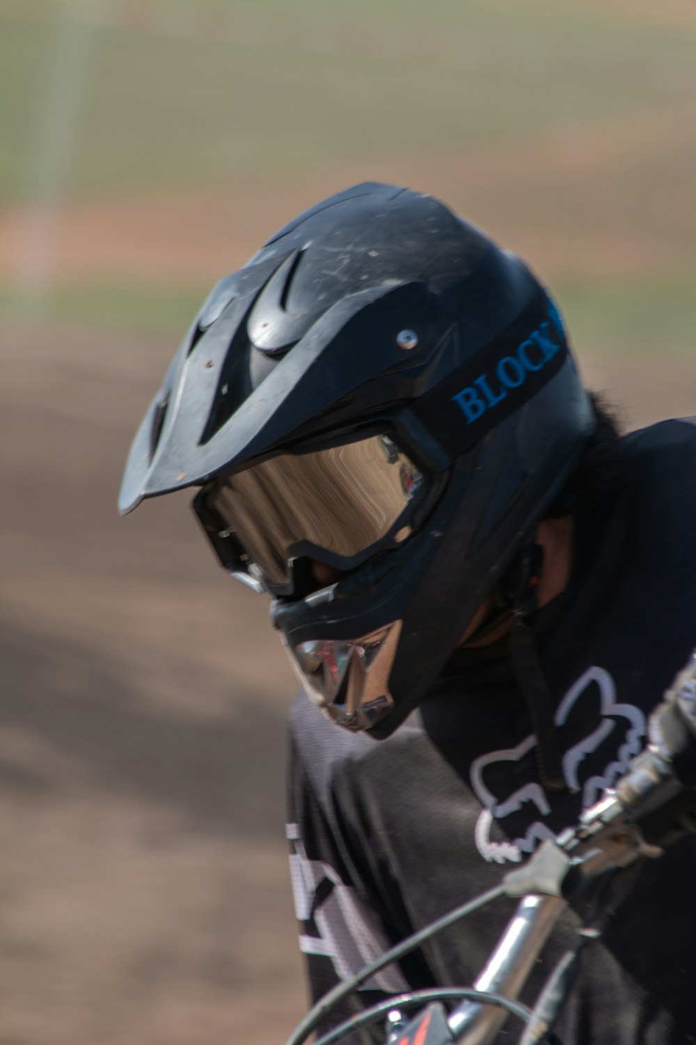 a close up of a person wearing a helmet on a bike