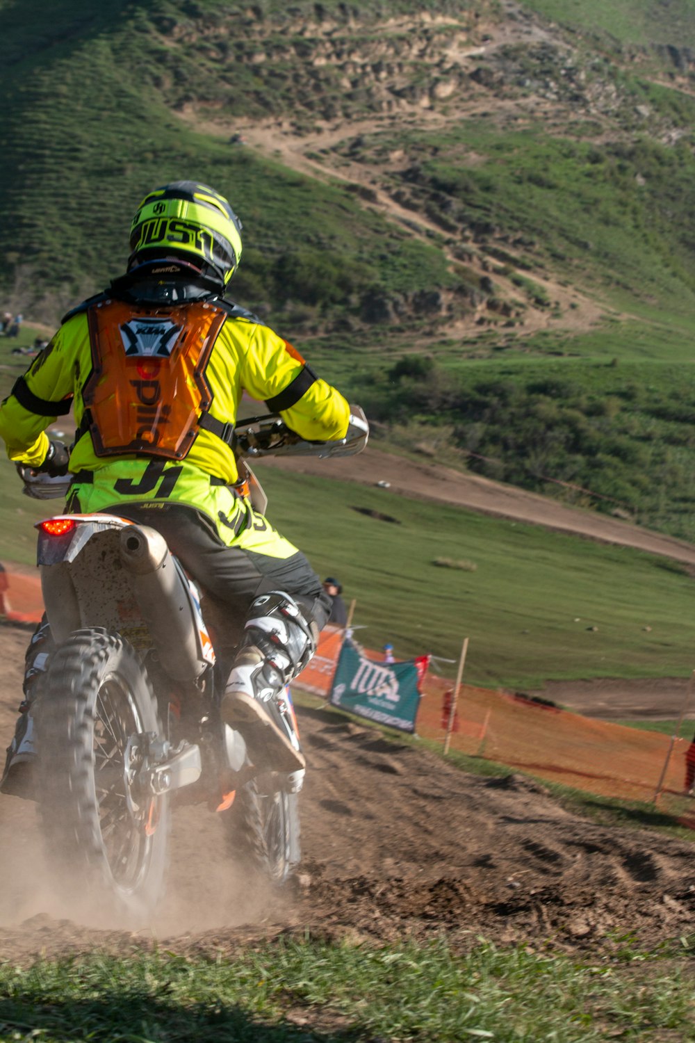 a person riding a dirt bike on a dirt track