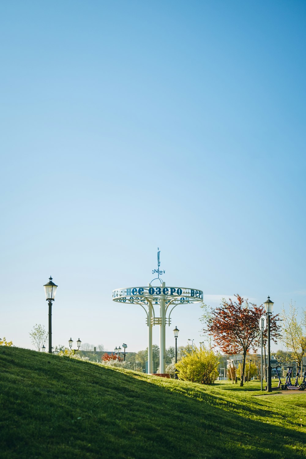 a park with a sign and a light pole