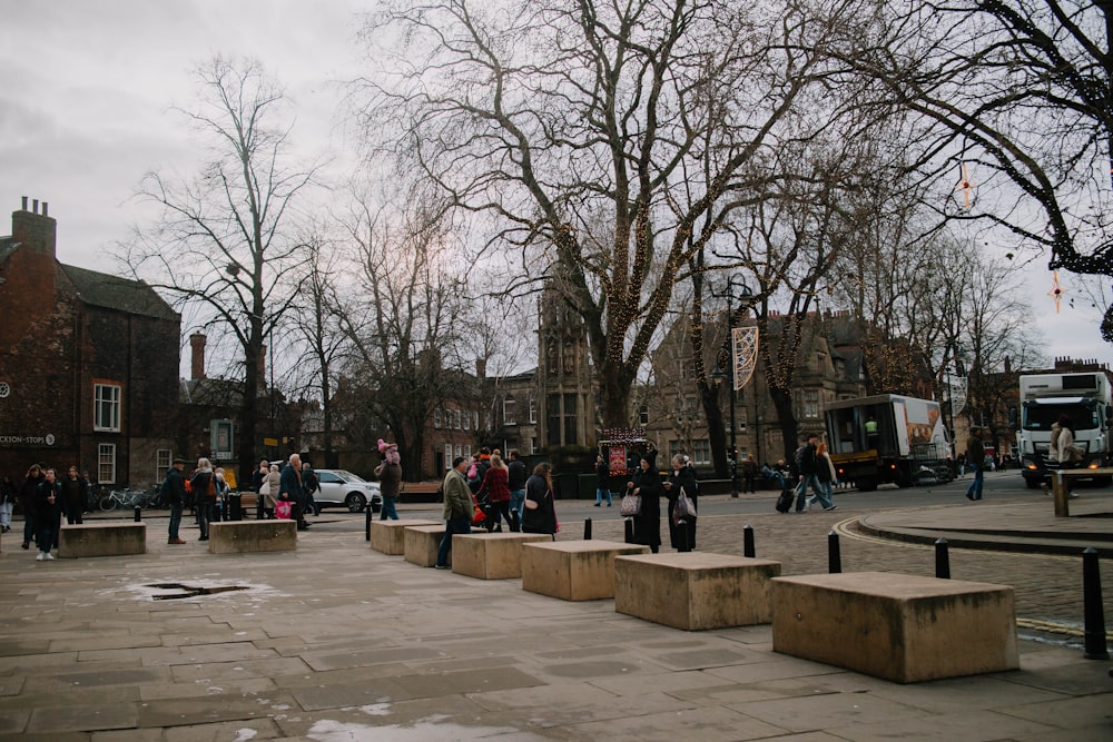 a group of people walking around a city square