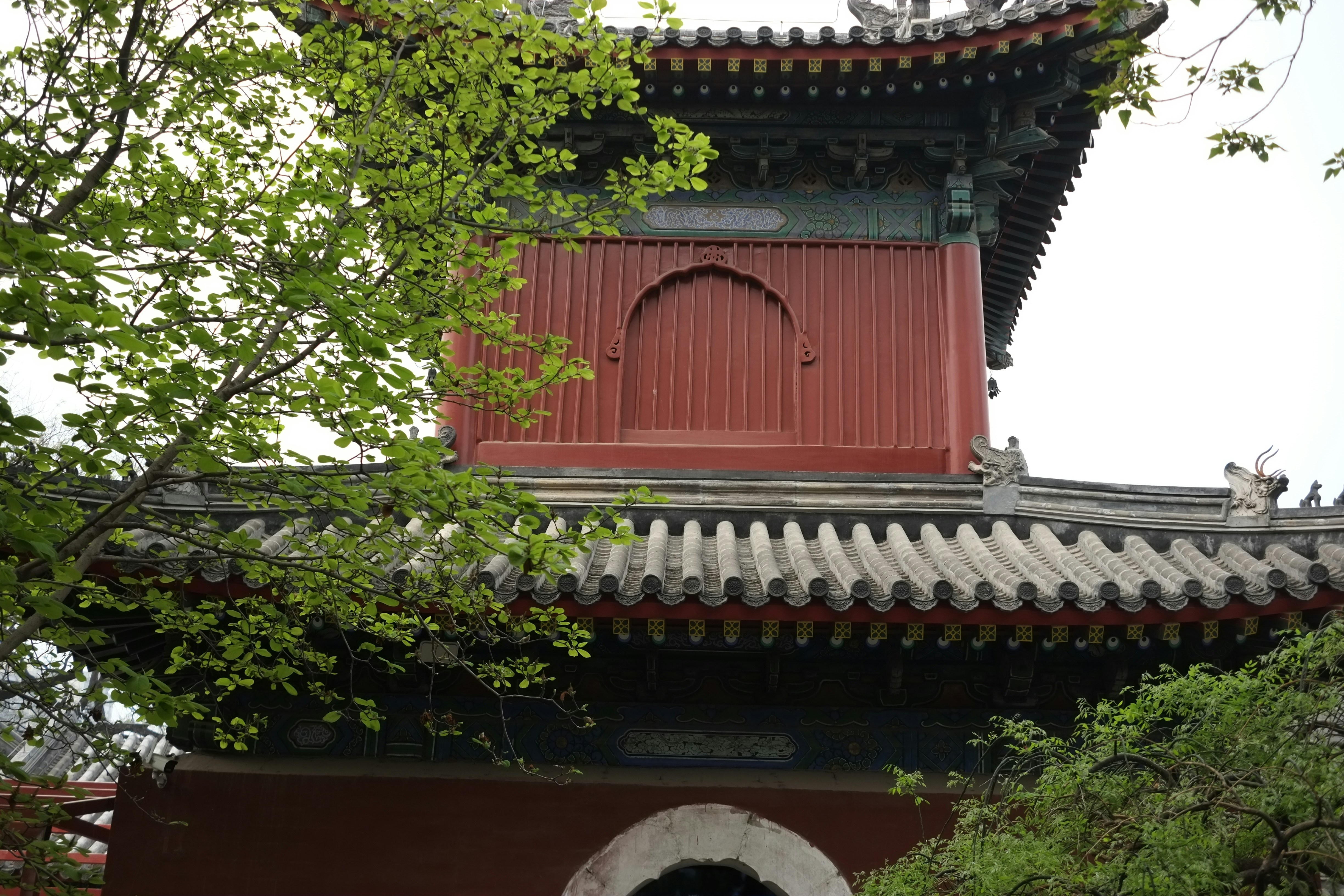 a building with a red roof and a white door