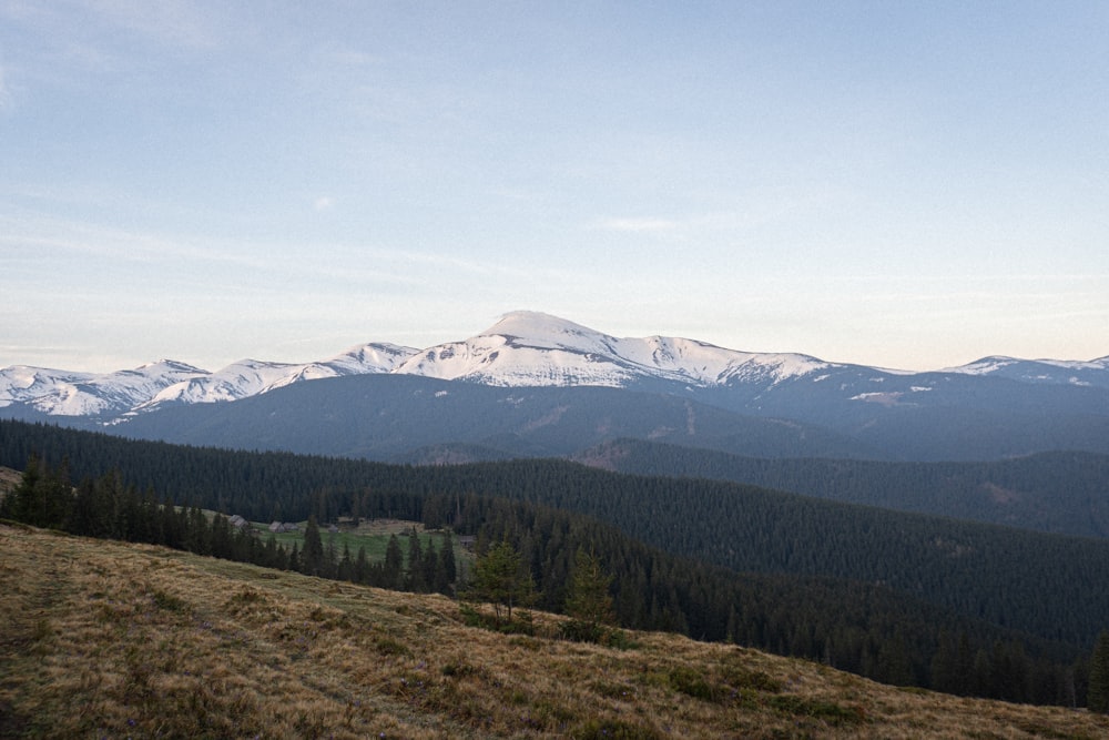 a view of a mountain range with snow capped mountains in the distance