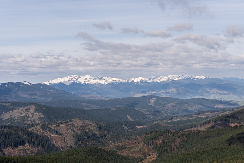 a view of a mountain range with snow capped mountains in the distance