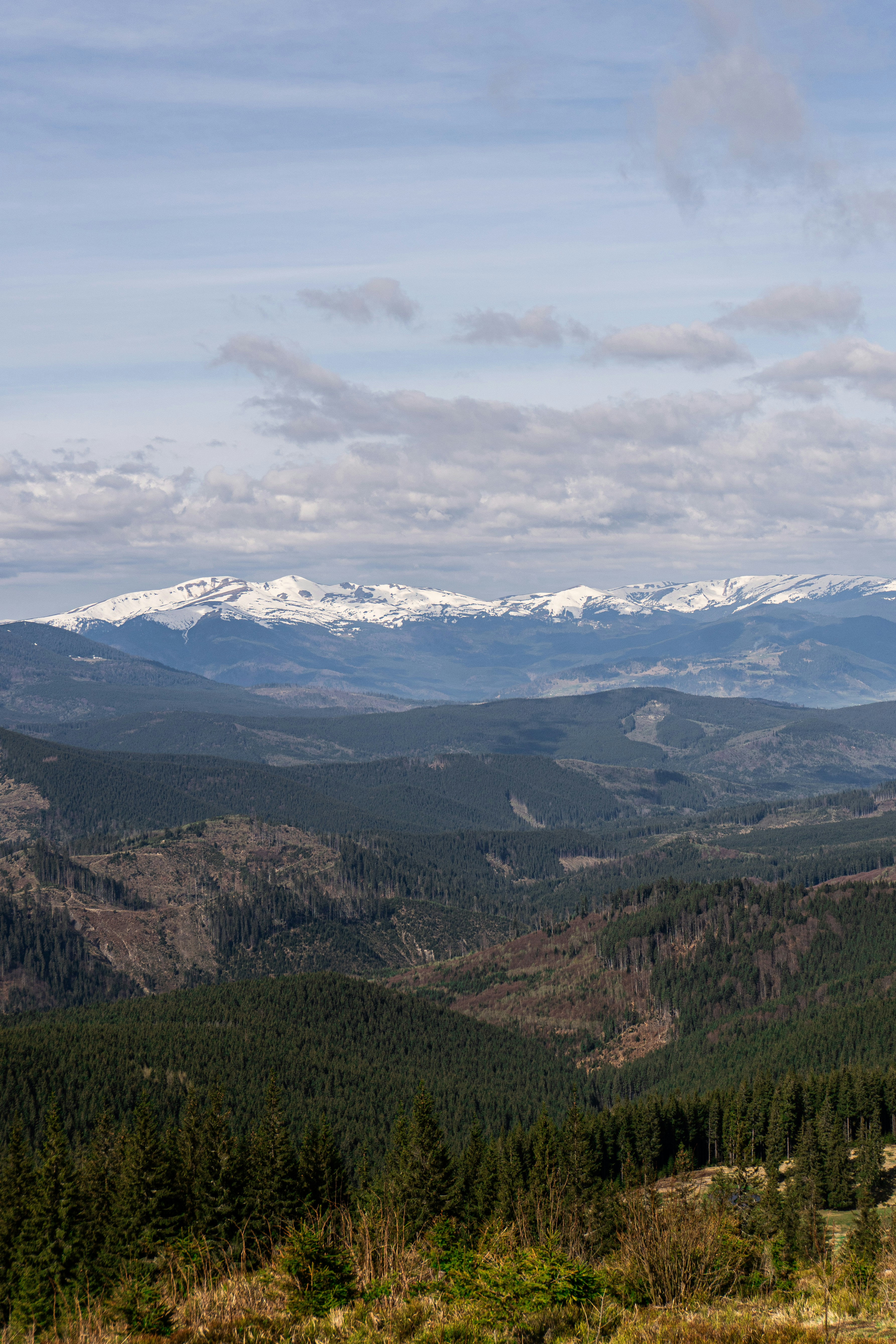 a view of a mountain range with snow capped mountains in the distance