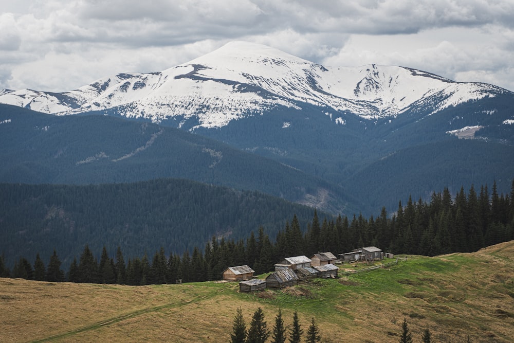 a view of a mountain range with houses in the foreground