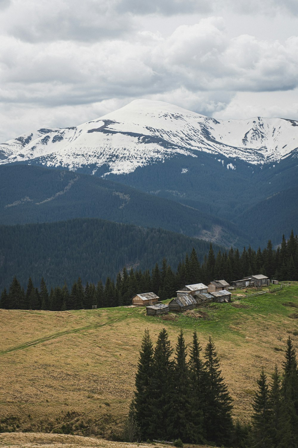 a view of a mountain range with houses in the foreground