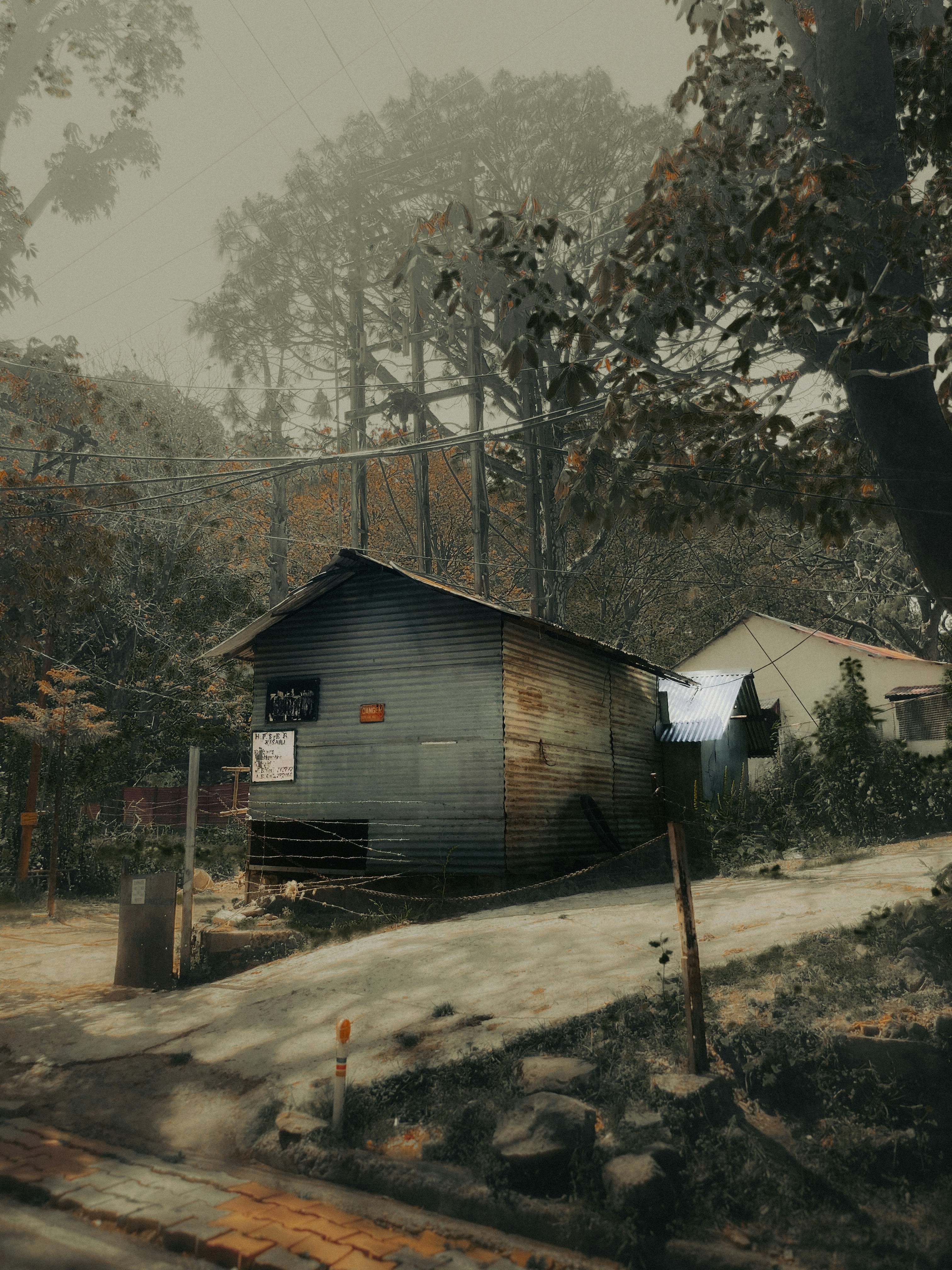 A house sitting on top of a hill next to a forest