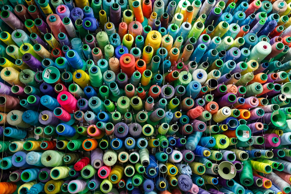 a large amount of spools of thread and needles