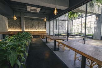 a room with tables and plants in it