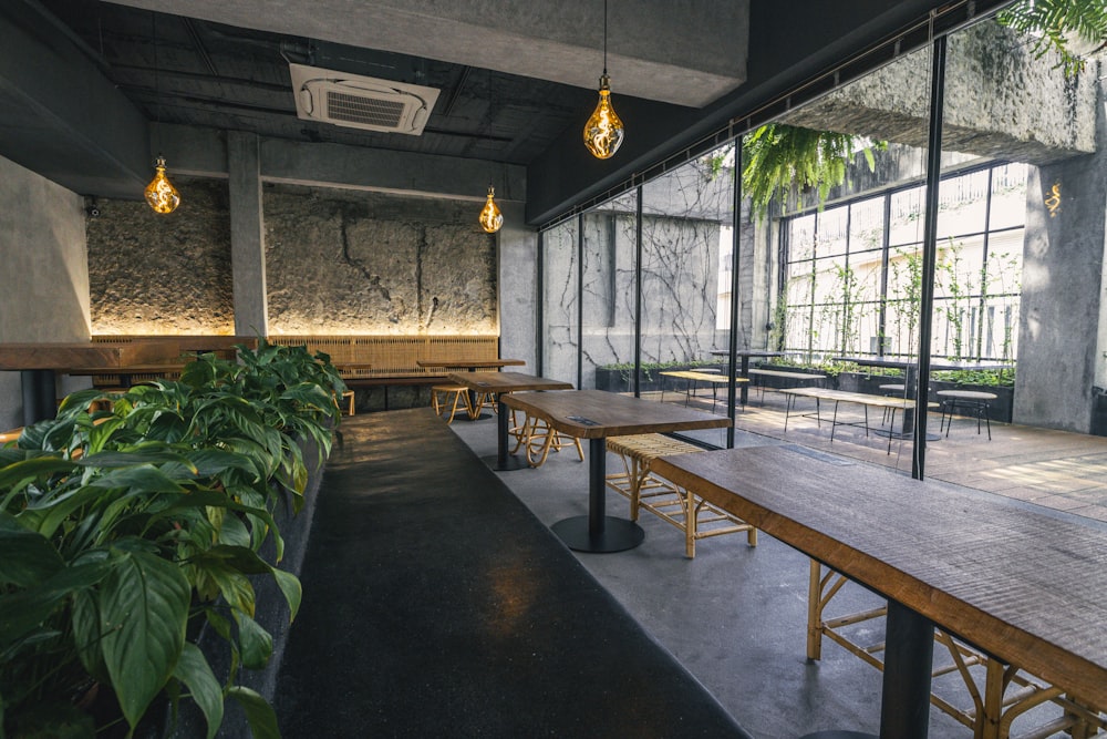 a room with tables and plants in it