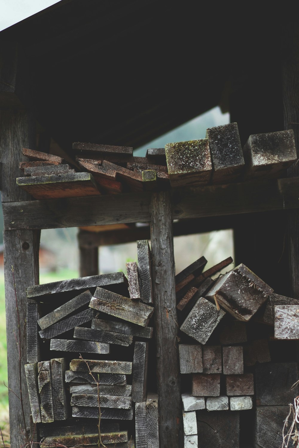 a pile of wood sitting under a wooden structure