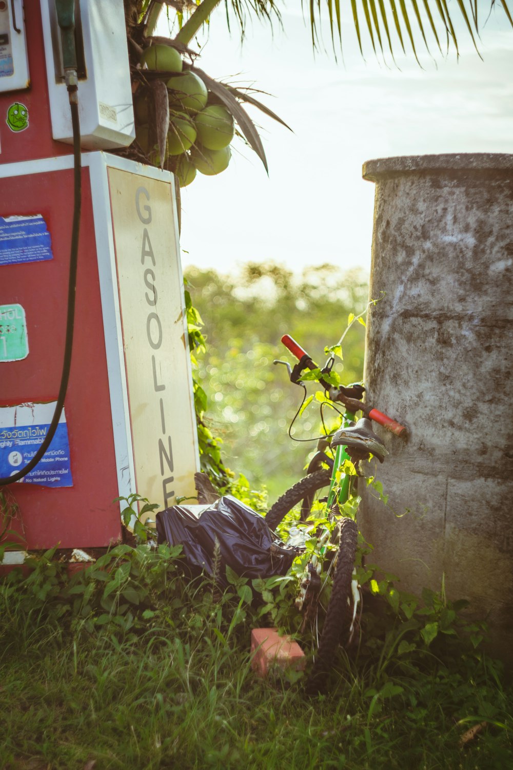 a bicycle parked next to a gas pump