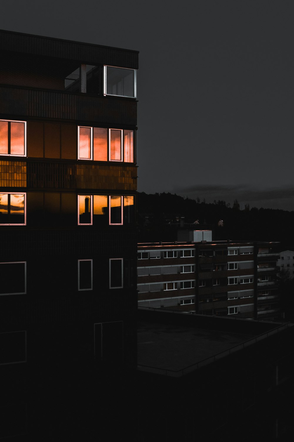 a tall building with windows lit up at night