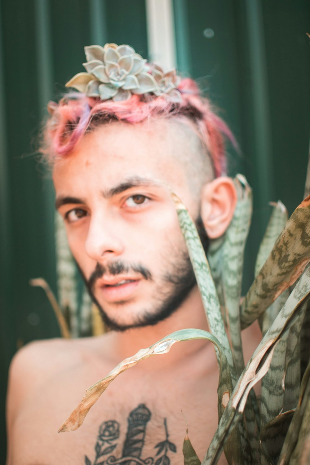 a man with pink hair and a crown on his head