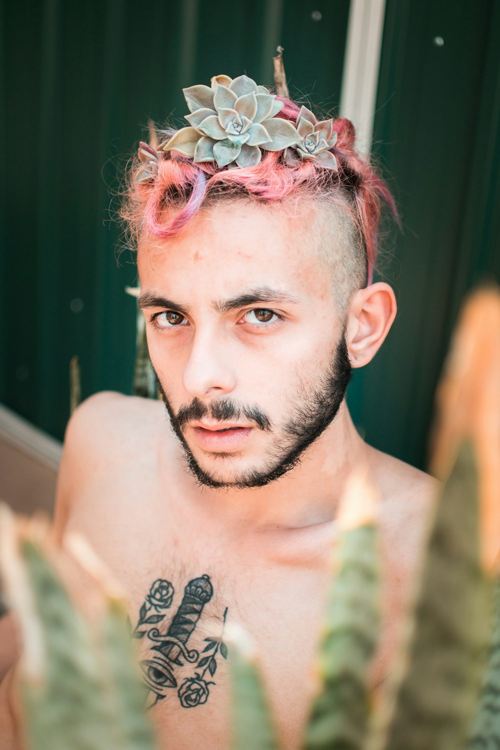 a man with pink hair and a crown on his head