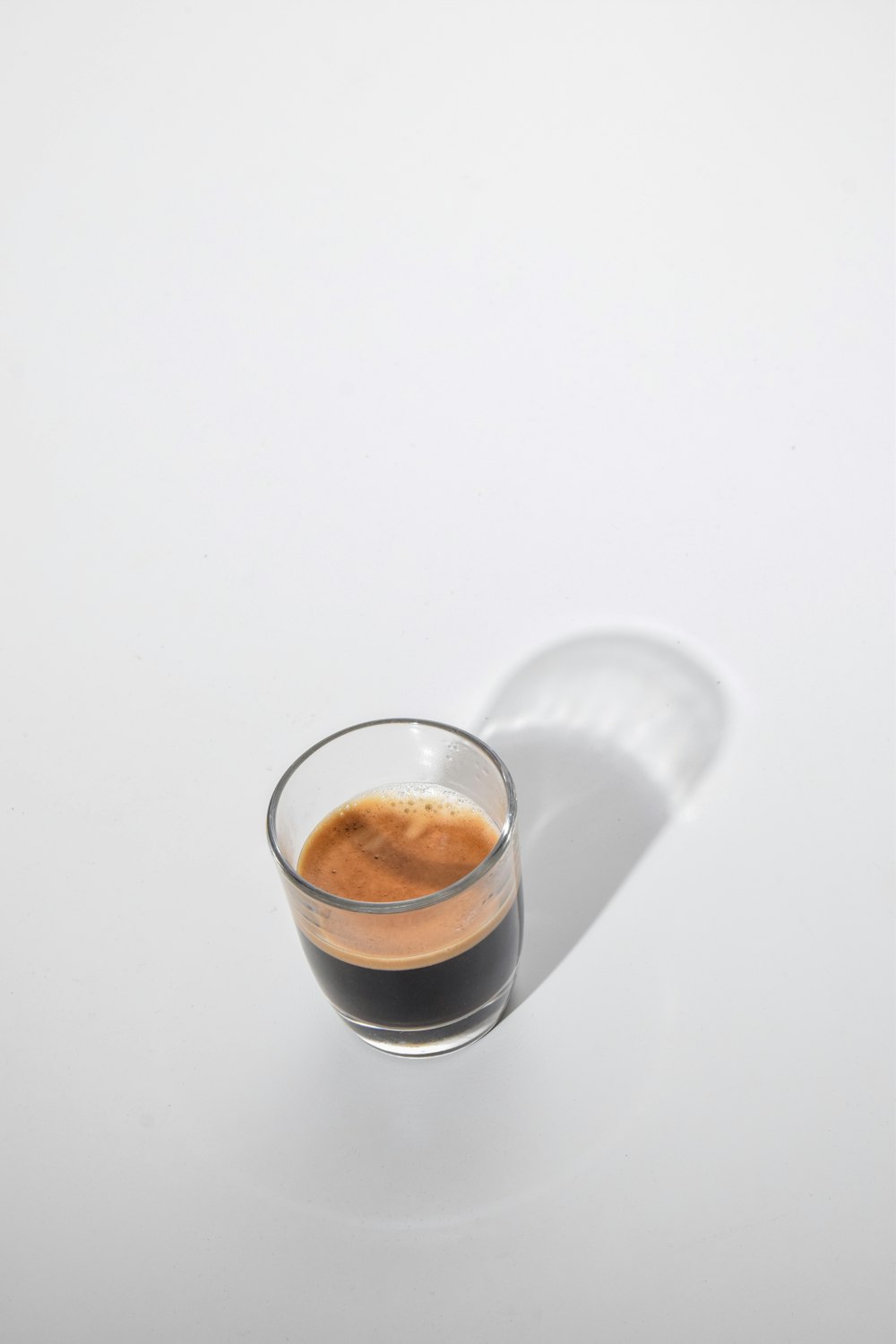 a cup of coffee sitting on top of a white table