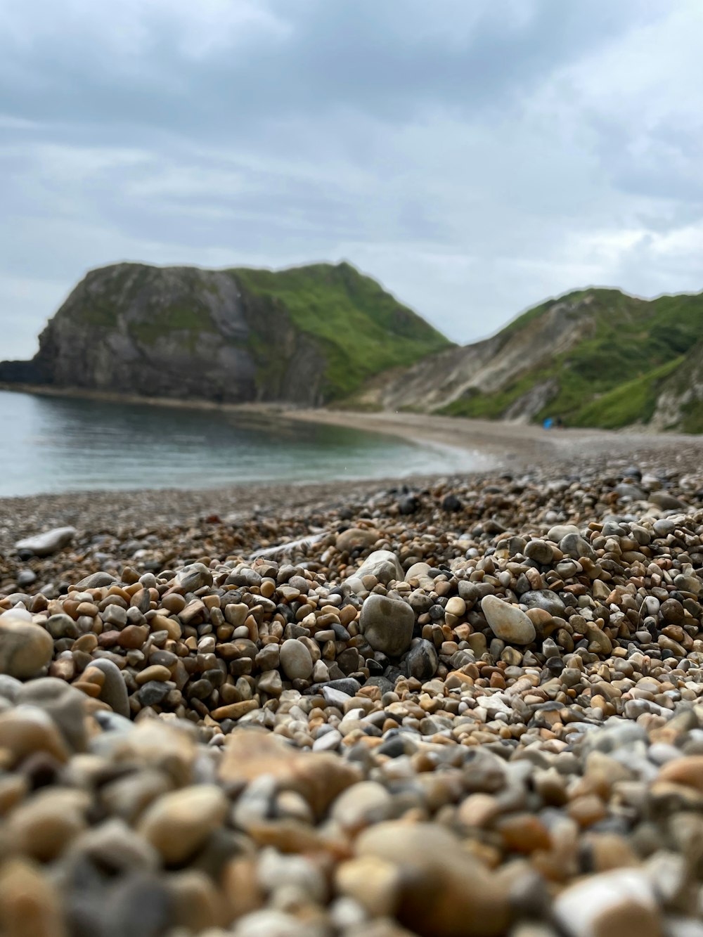 a bunch of rocks that are on a beach