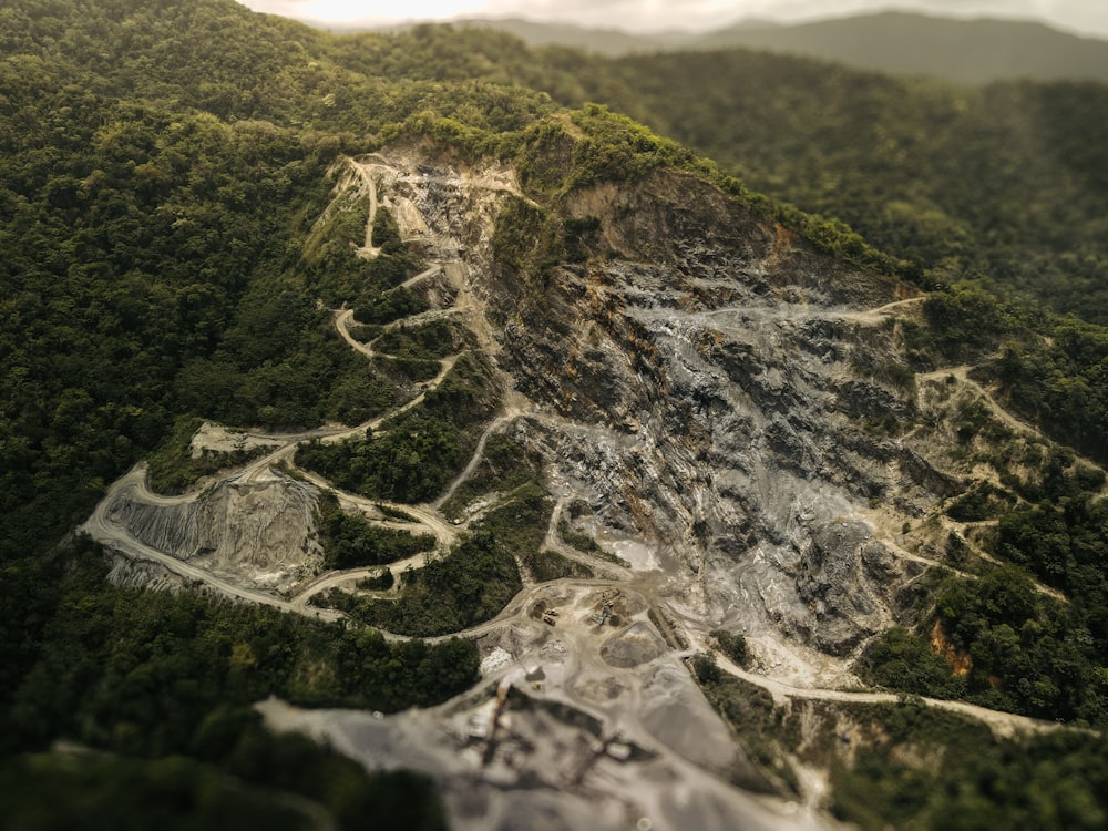 an aerial view of a mountain with trees