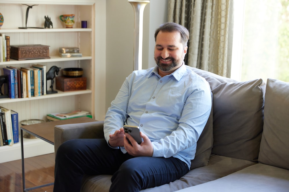 male browsing on internet and smiling 