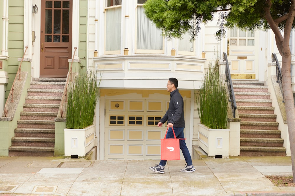 man walking with DoorDash bag