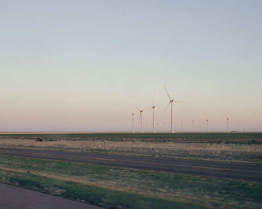 a wind farm is seen from a moving car