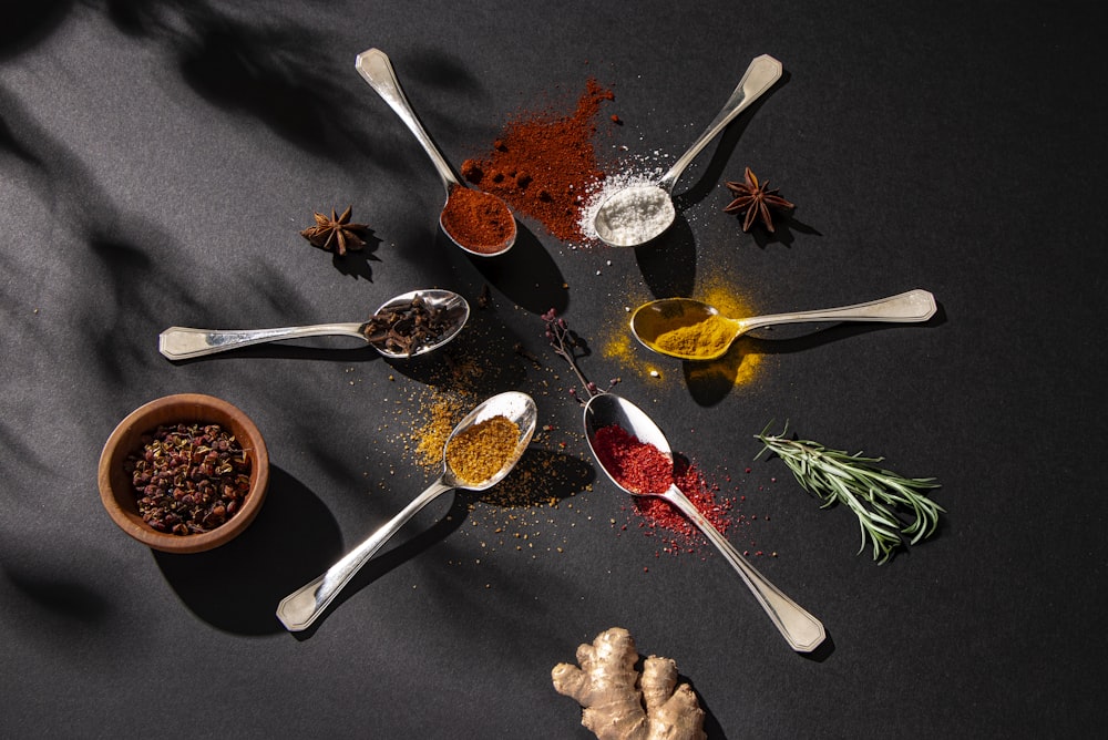 a group of spoons filled with different types of spices