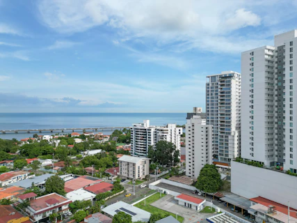 a view of a city with a body of water in the background