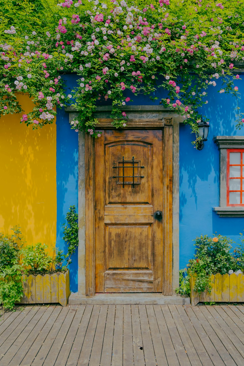 a blue and yellow house with a wooden door