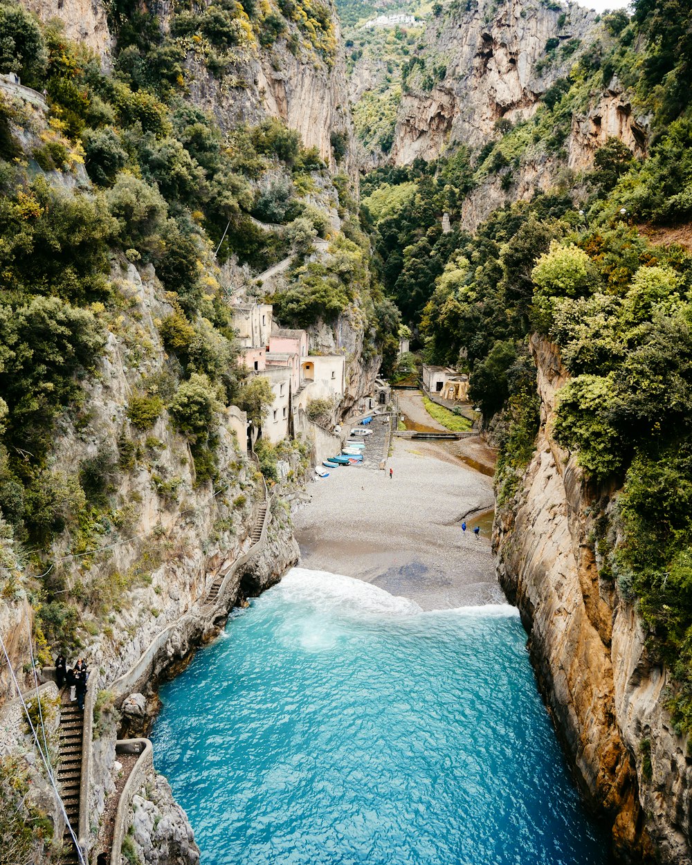 a river running through a lush green hillside