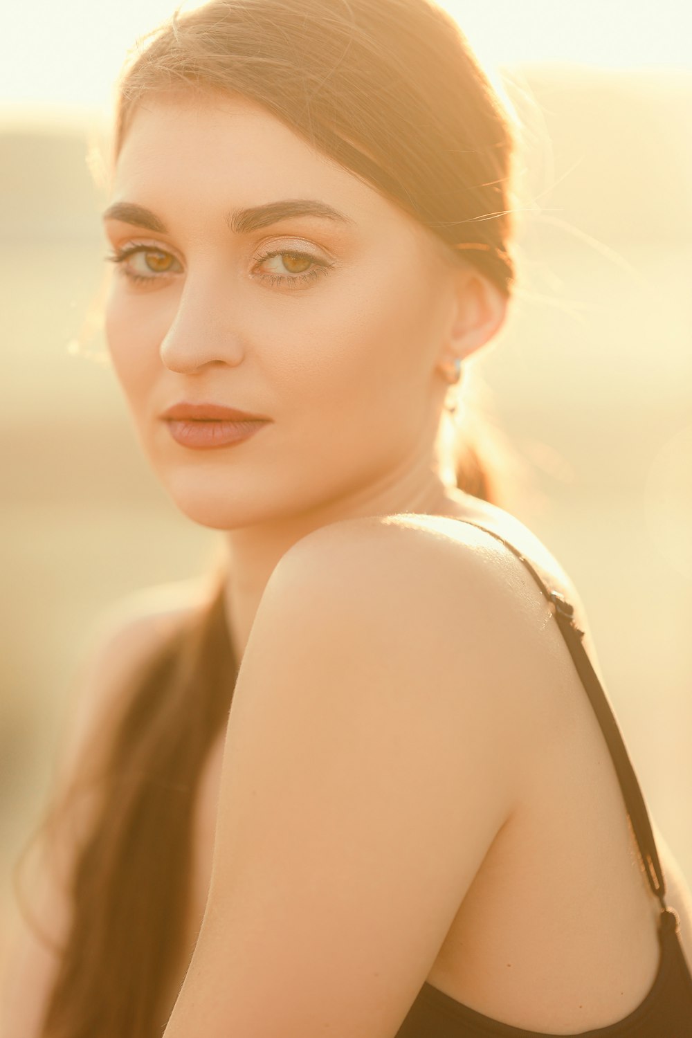 a woman in a black dress posing for a picture