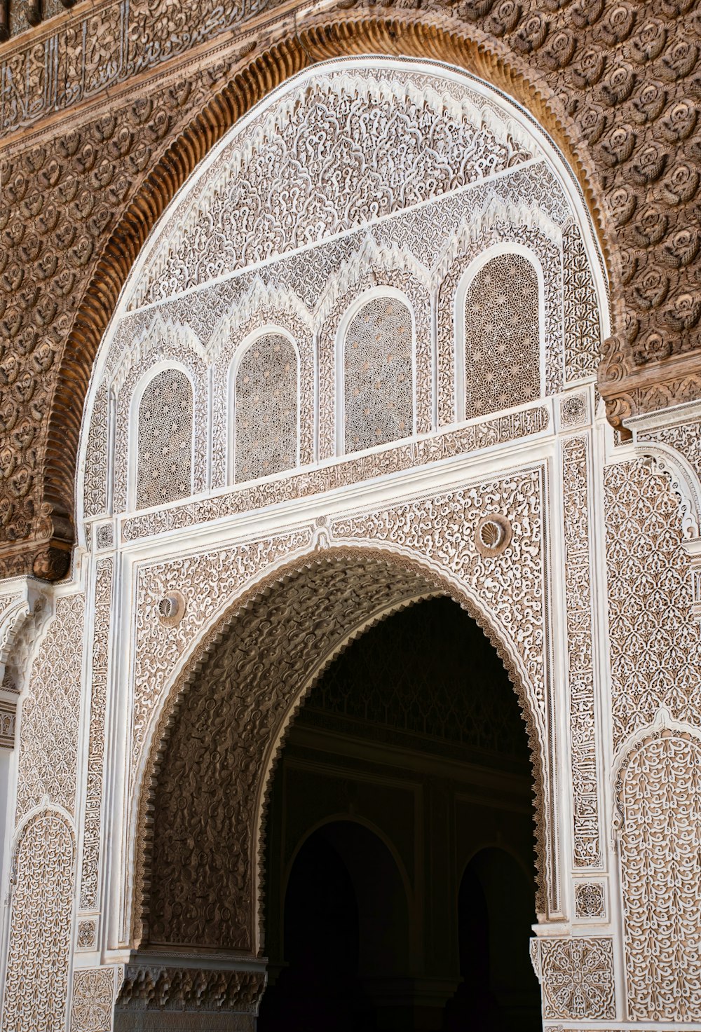 an ornate archway in a building with a clock on the wall