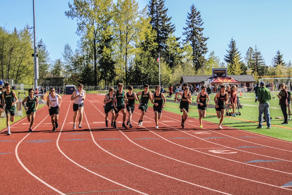 a group of people running on a track