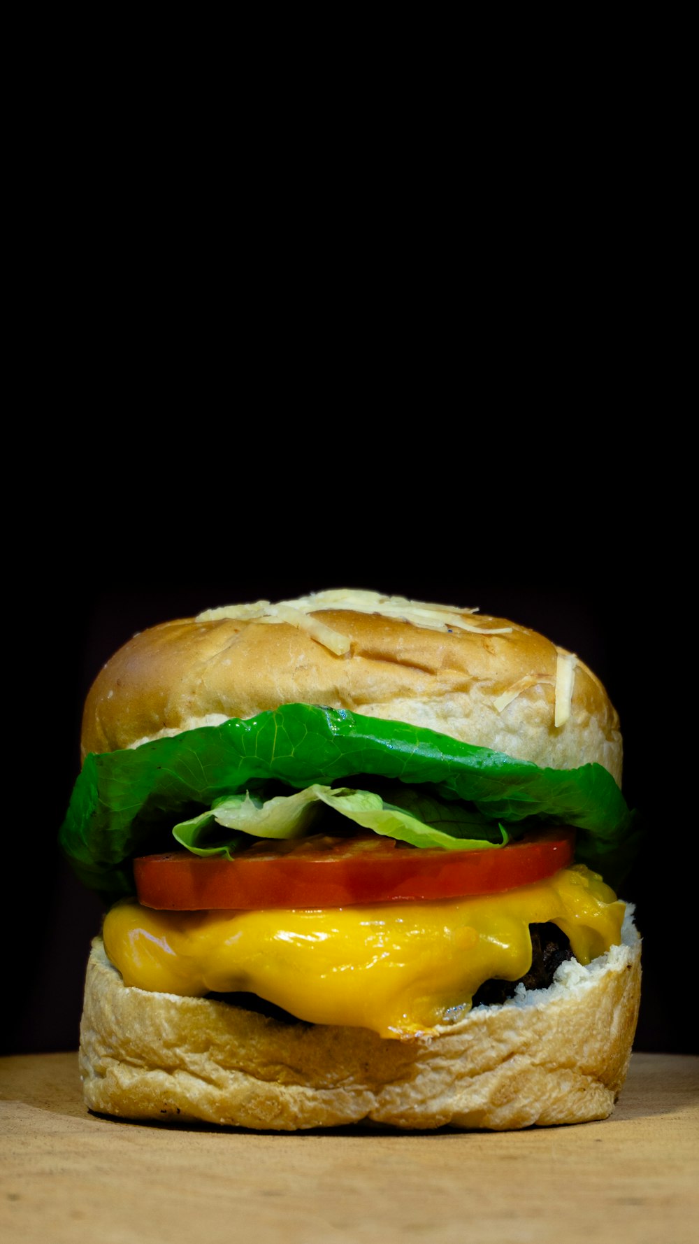 a cheeseburger with lettuce, tomato, and cheese