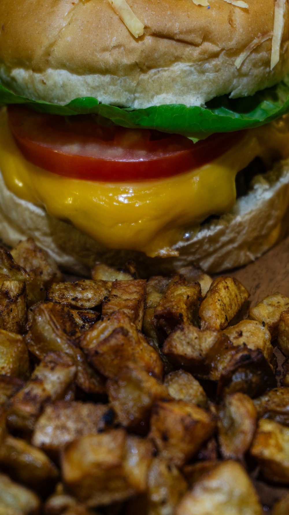 a close up of a sandwich on a plate with potatoes