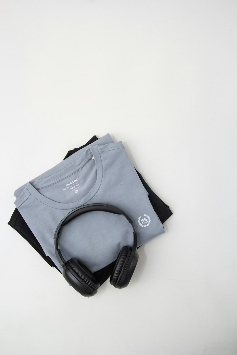 a pair of headphones sitting on top of a t - shirt