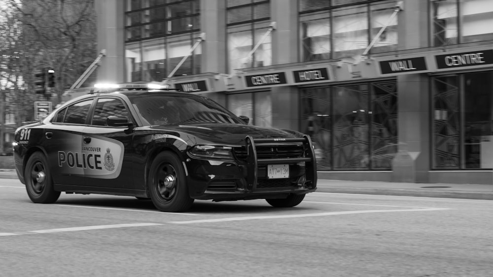 a police car driving down a city street