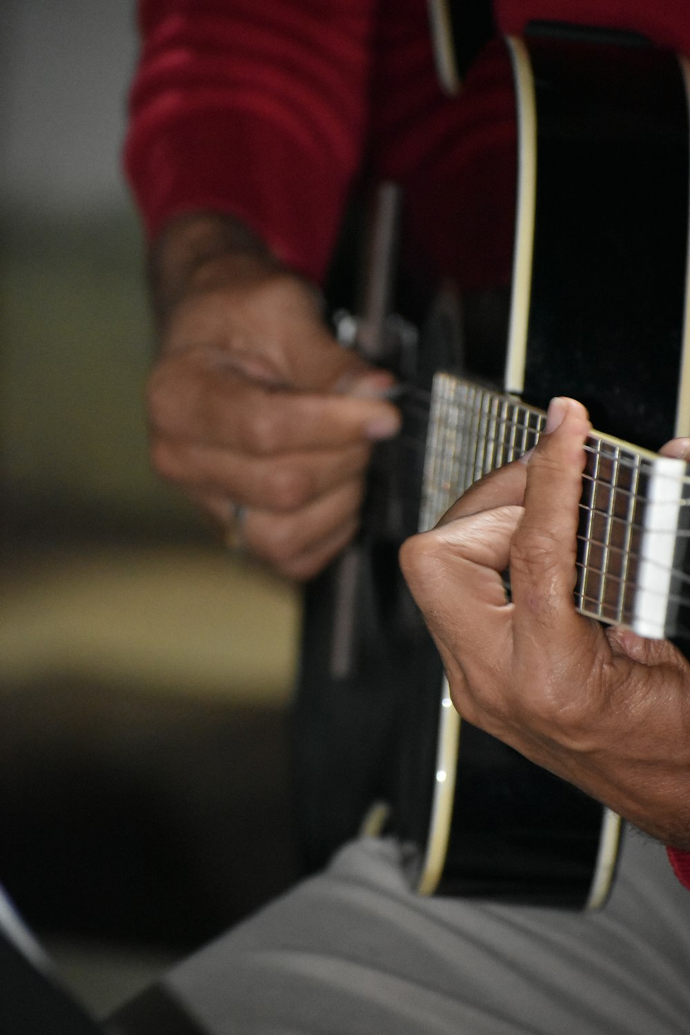 a close up of a person playing a guitar