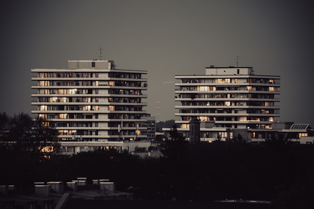 a couple of tall buildings sitting next to each other