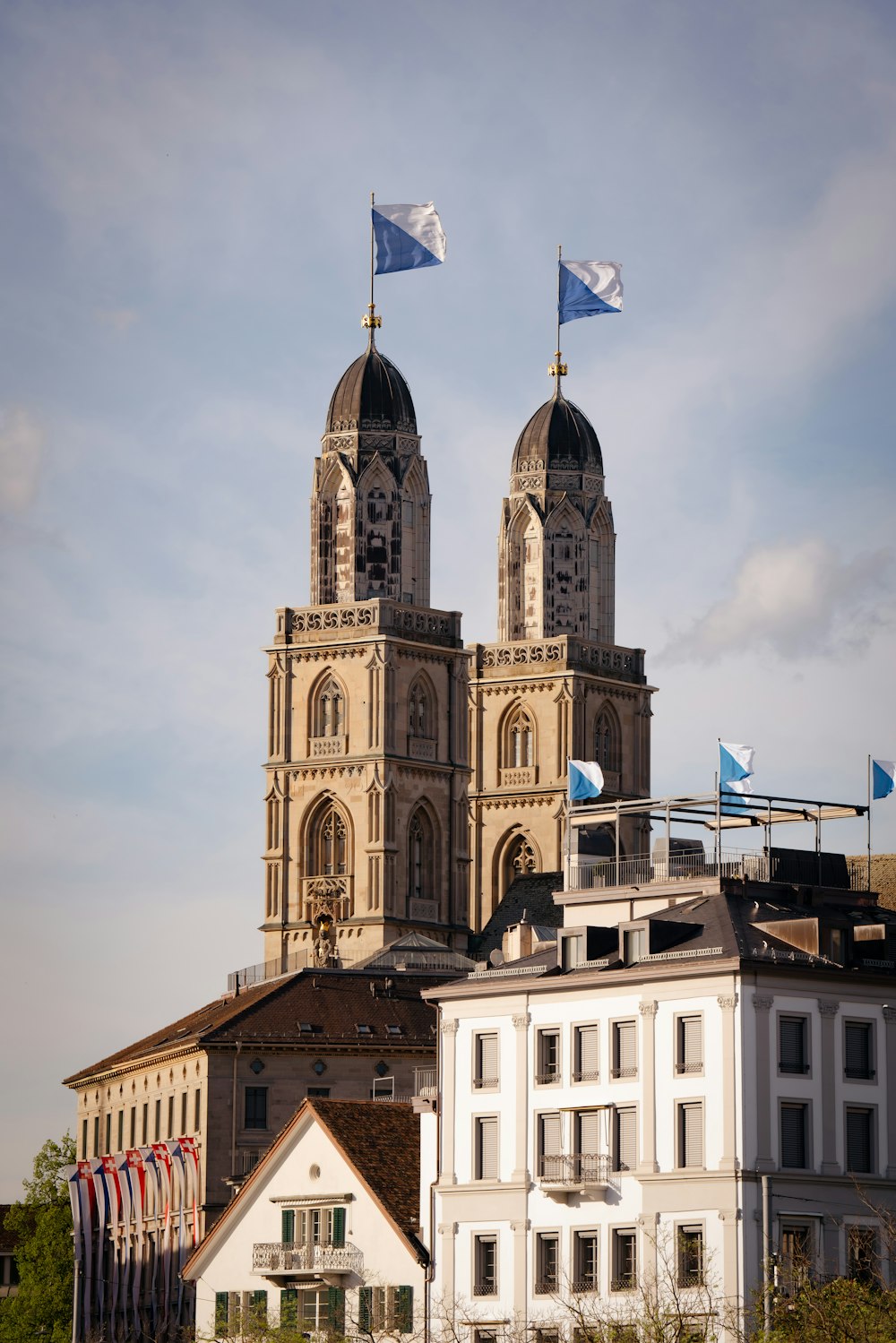 a large building with two towers and two flags on top of it