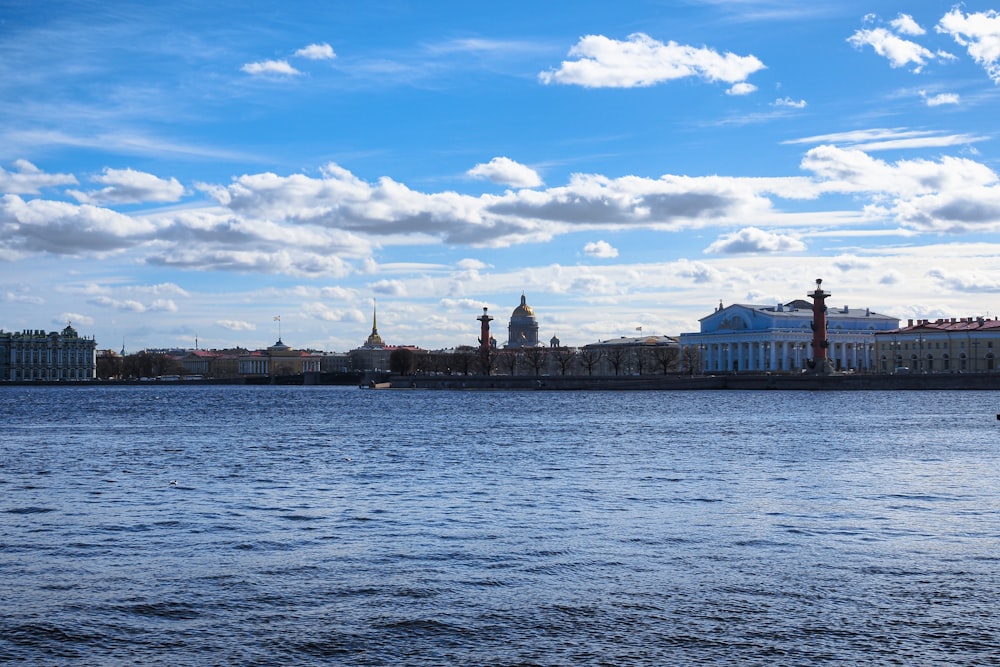 a large body of water with buildings in the background