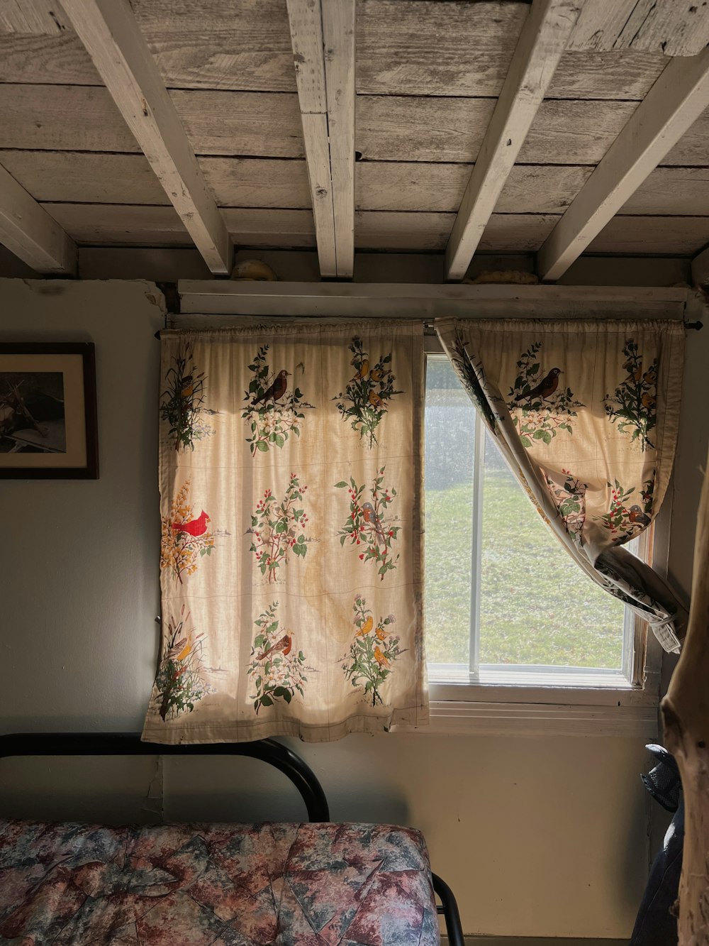 a bed sitting under a window next to a window