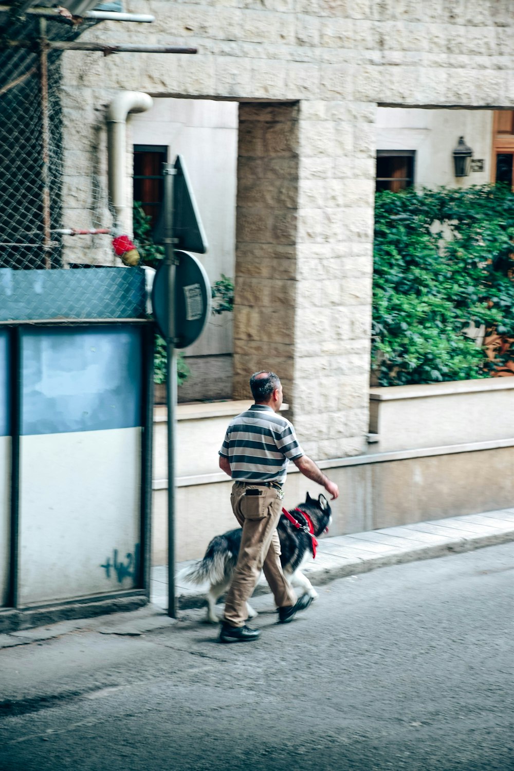 a man walking his dog down the street