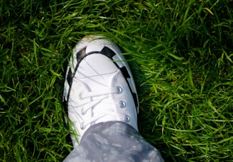a person standing on top of a lush green field