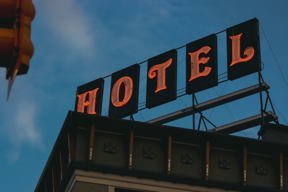 a hotel sign lit up on top of a building