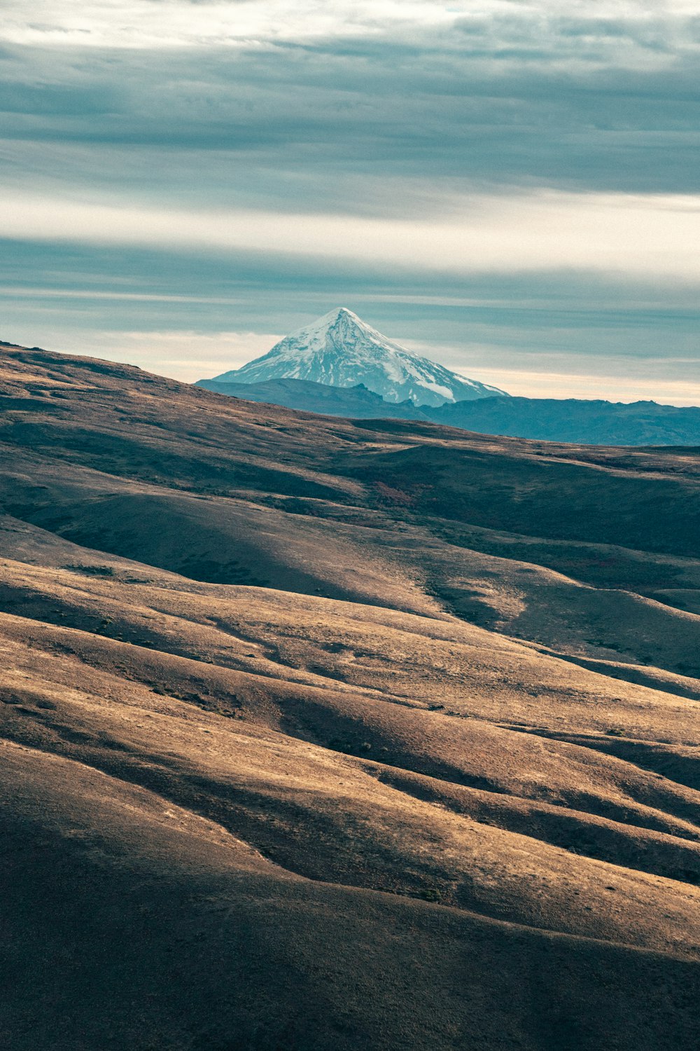 a mountain with a snow capped peak in the distance