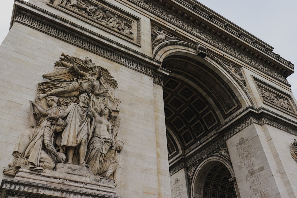 a large stone arch with statues on it