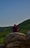 a man sitting on top of a large rock