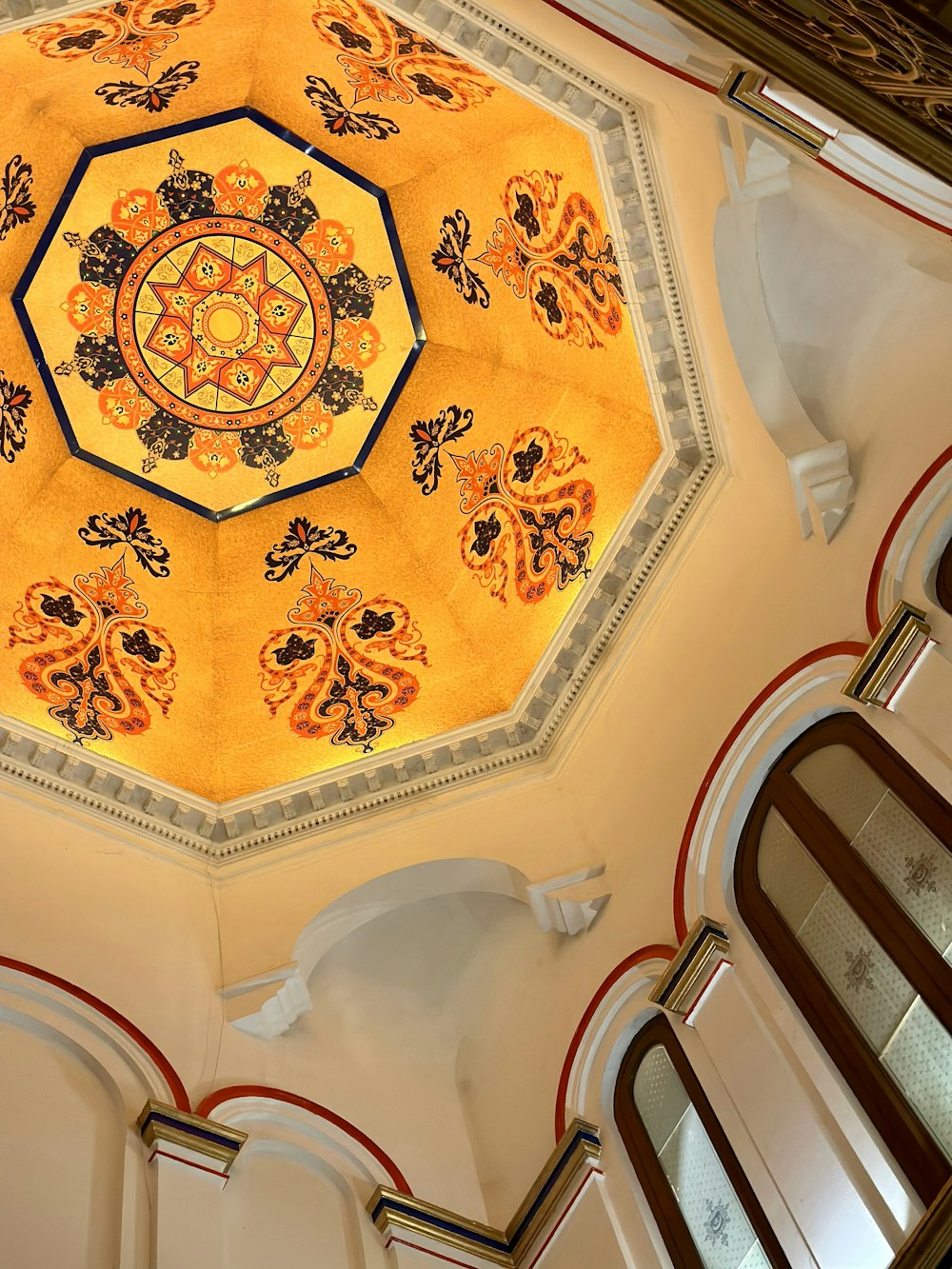 the ceiling of a building with a circular design on it