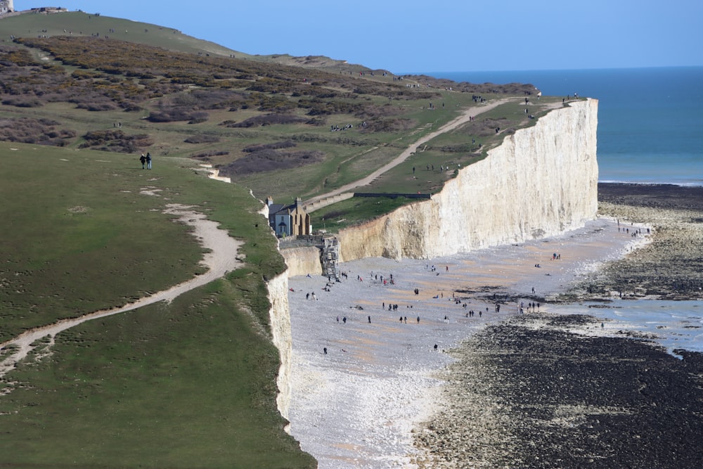 a group of people standing on the edge of a cliff